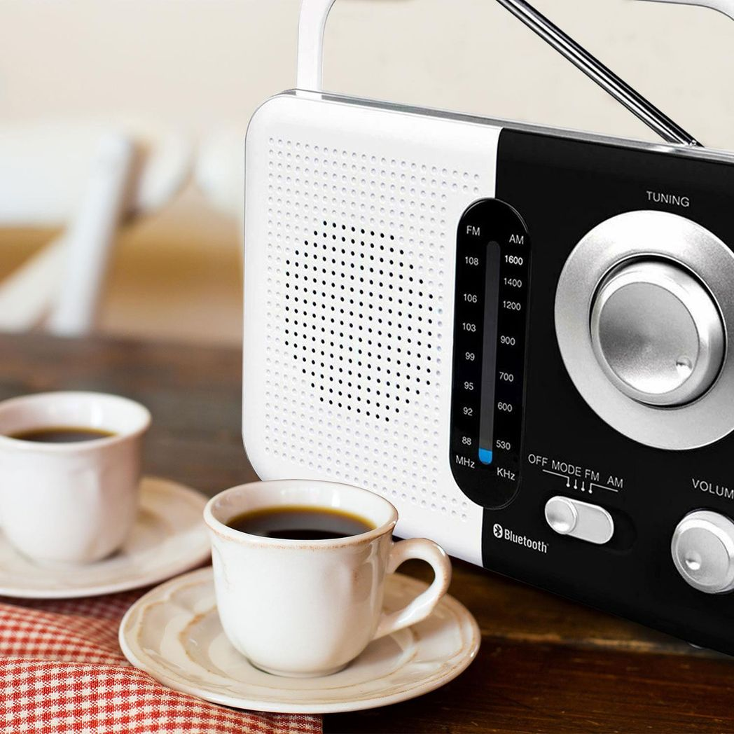 Black and white Soundz AM/FM Bluetooth radio with USB port and SD card slot, showcasing its sleek design and controls.