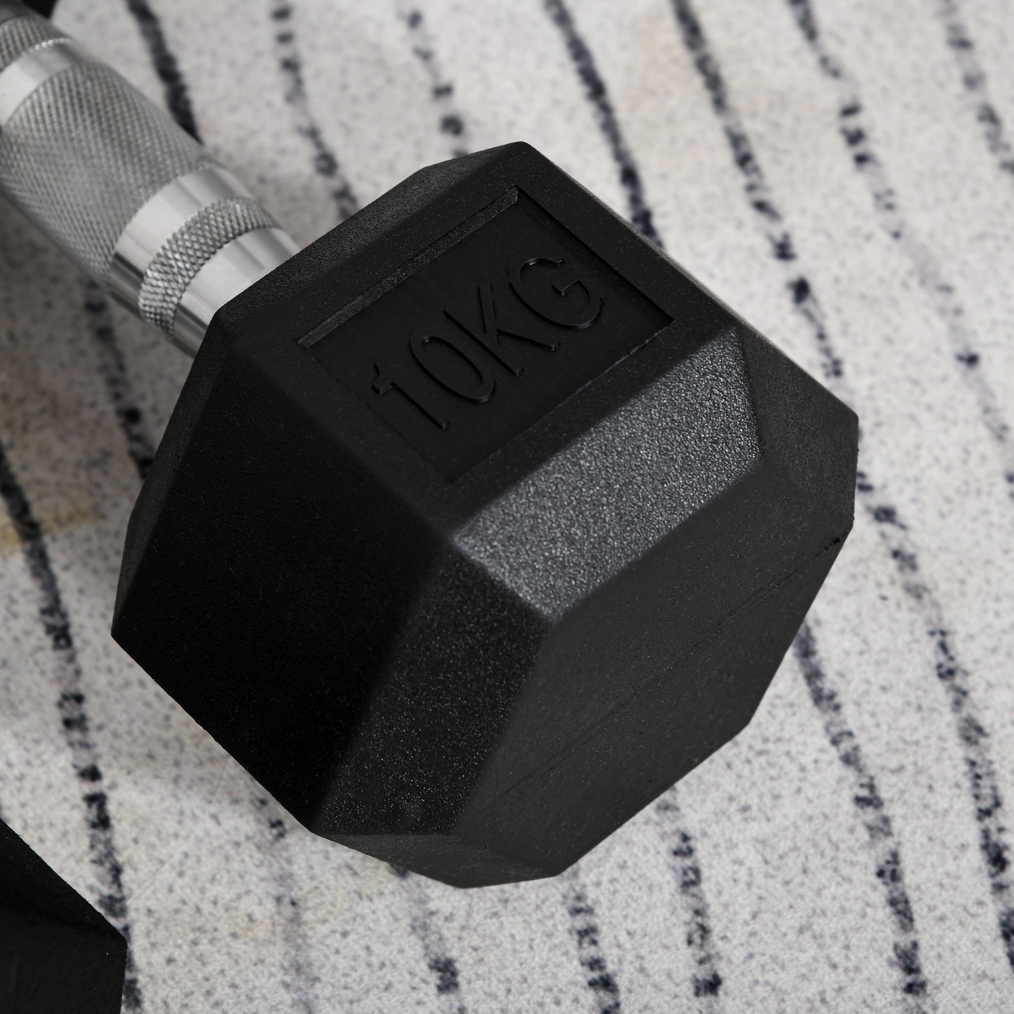 Hexagonal 10kg dumbbells for weight lifting, featuring a sturdy design for home fitness workouts.