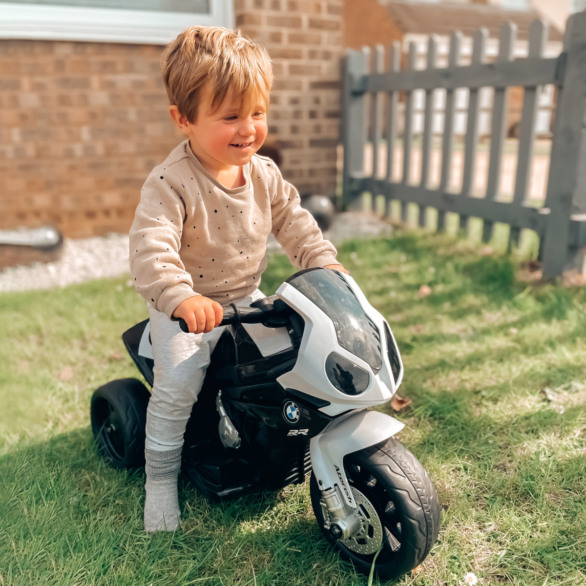 Black BMW licensed electric kids ride-on motorcycle with headlights and music by HOMCOM. Ideal for outdoor fun.