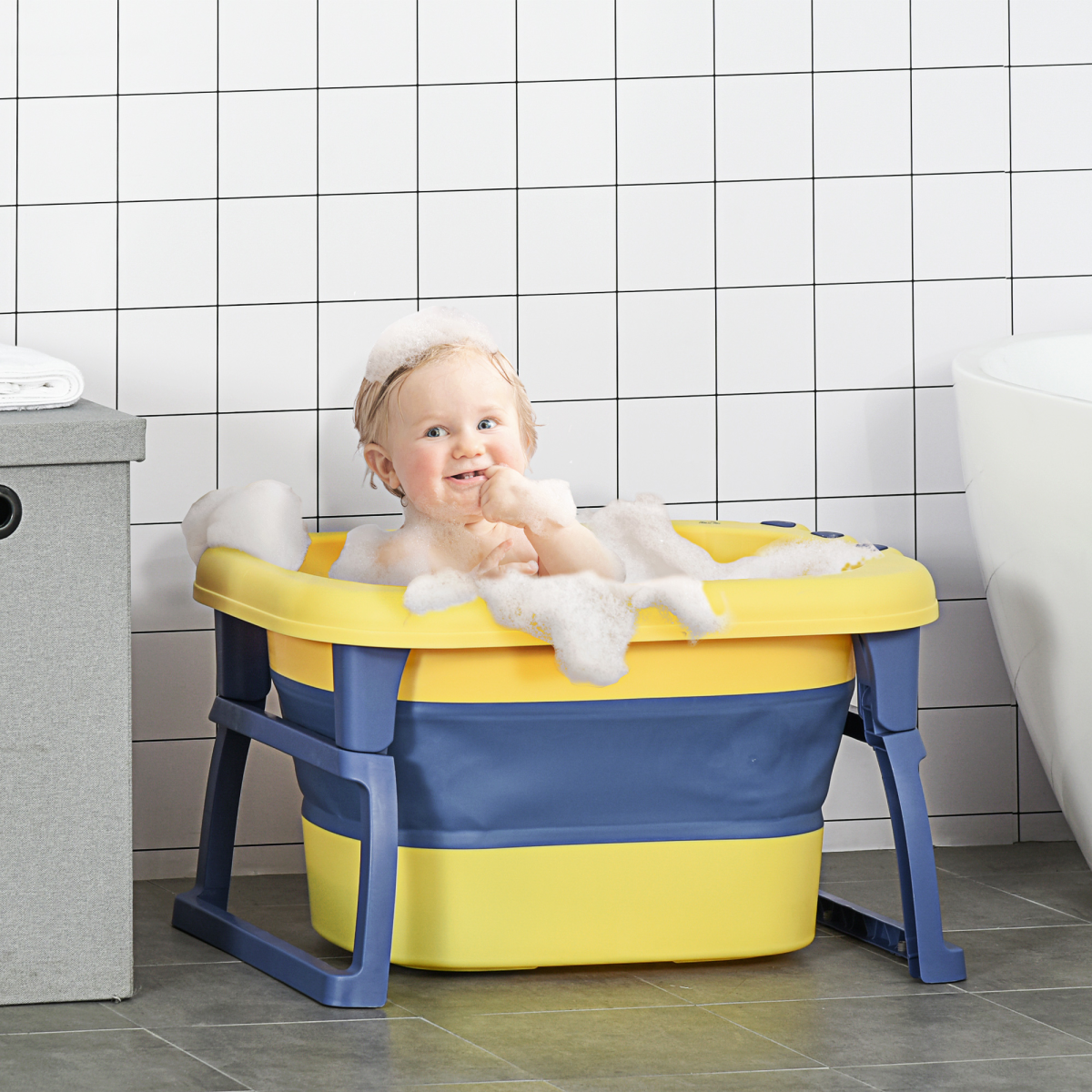 Foldable yellow baby bathtub for newborns and toddlers by HOMCOM, featuring a convenient stool for easy bathing.