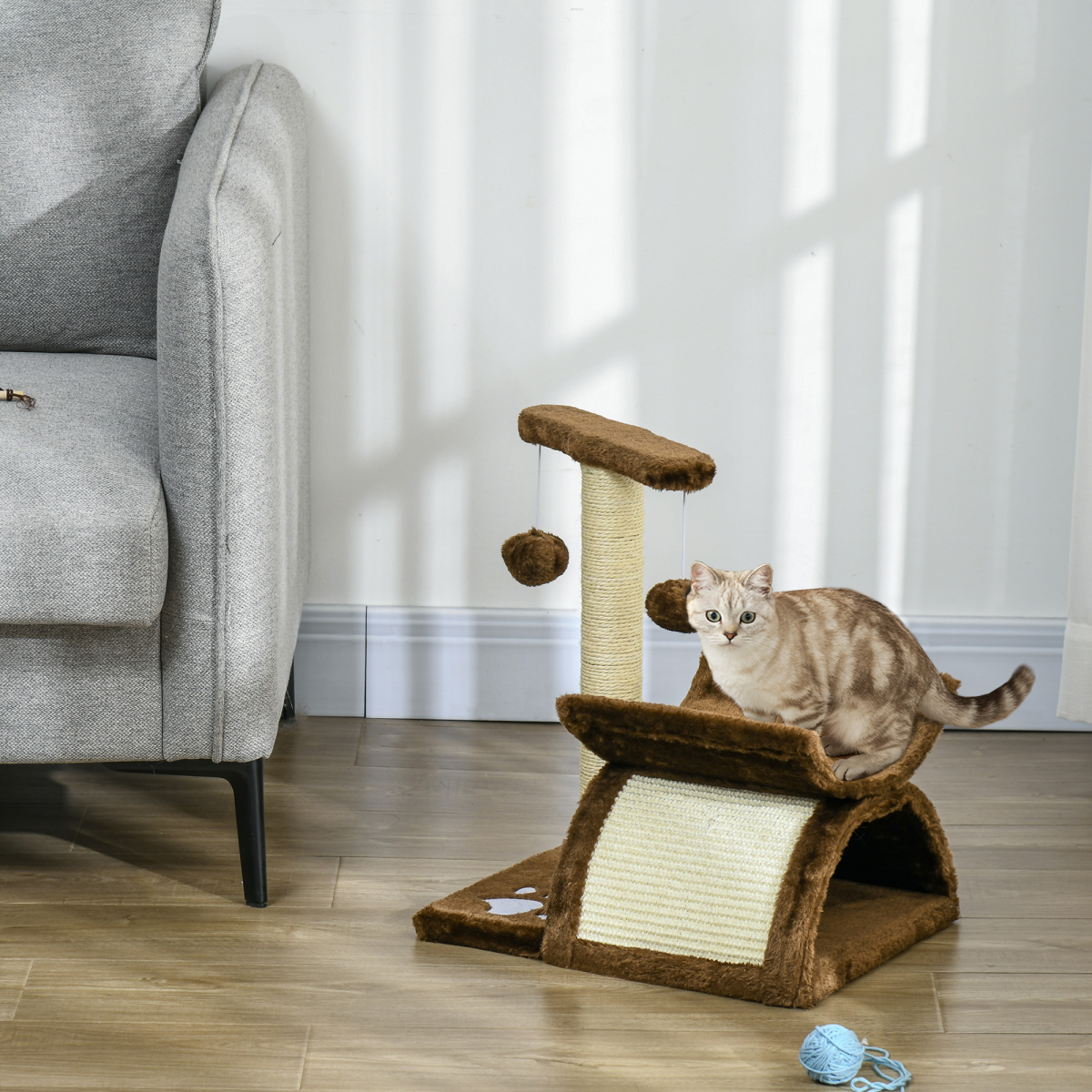 Pawhut cat tree with plush scratching posts, top bar tunnel, and dangling ball for kitty play and activity.