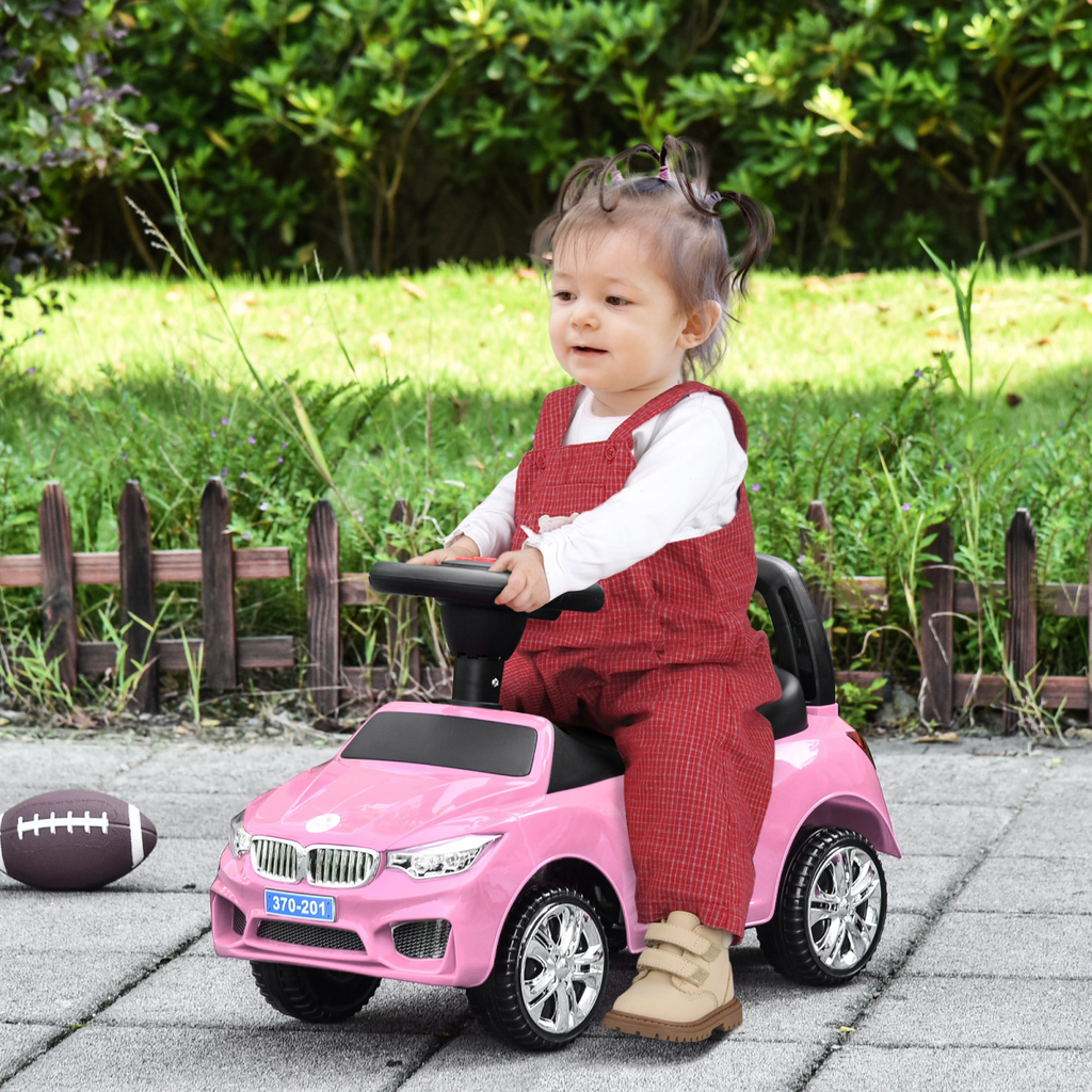 Pink HOMCOM Ride on Car for toddlers, featuring a foot-to-floor design for easy sliding and walking fun.