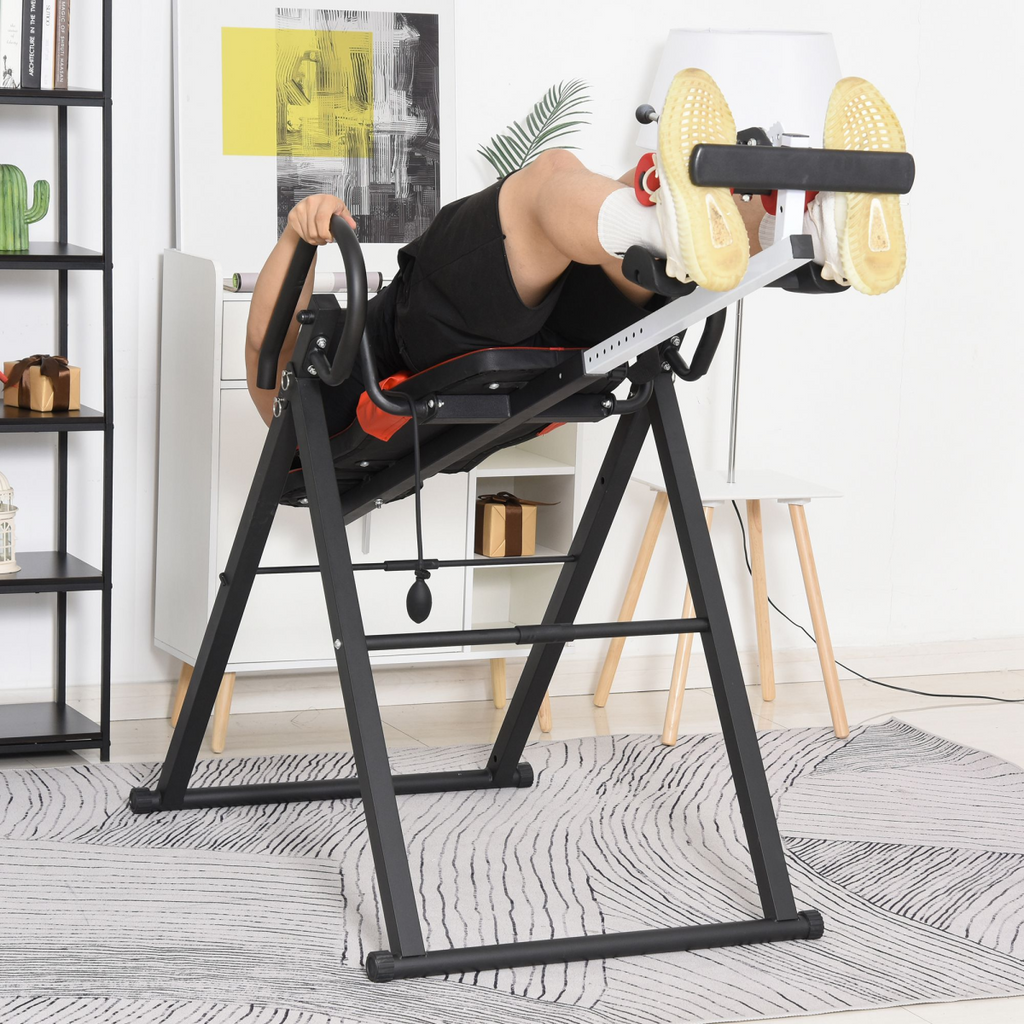 Adjustable gravity inversion table with safety belt for muscle pain relief, featuring a sturdy frame and padded support.