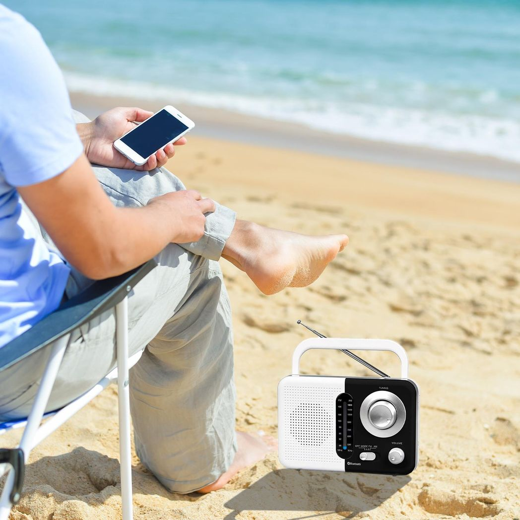 Soundz AM/FM Bluetooth radio in black and white with USB port and SD card slot, showcasing its sleek design and controls.