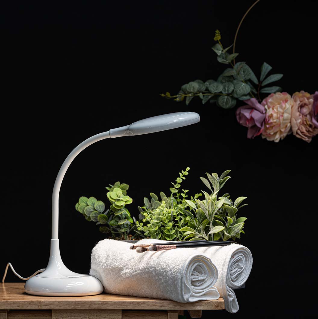 Native Lighting Desk Magnifier Lamp with 3X magnification and dimmable three color temperatures, illuminating a workspace.