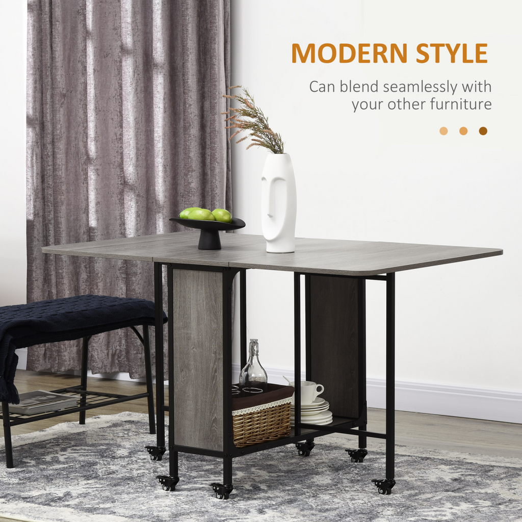 HOMCOM mobile drop leaf table with extendable design, seating for 6, and wheels for easy mobility in a dining space.