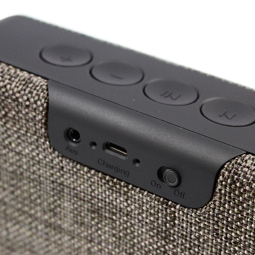 Brown Fabric Bluetooth Portable Speaker by Soundz, showcasing a sleek design and compact size for easy portability.