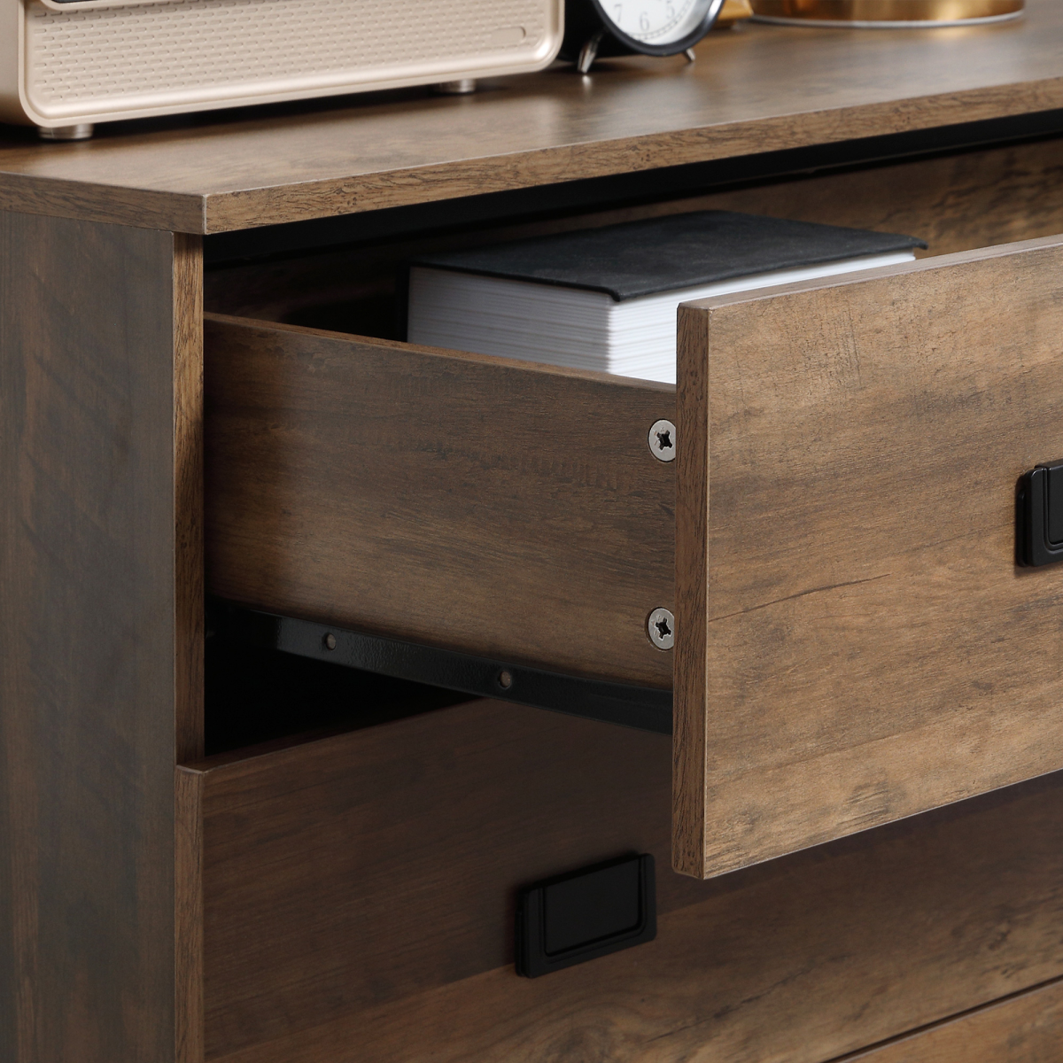 Rustic wood effect 4 drawer chest of drawers by HomeCraft, ideal for bedroom or living room storage solutions.