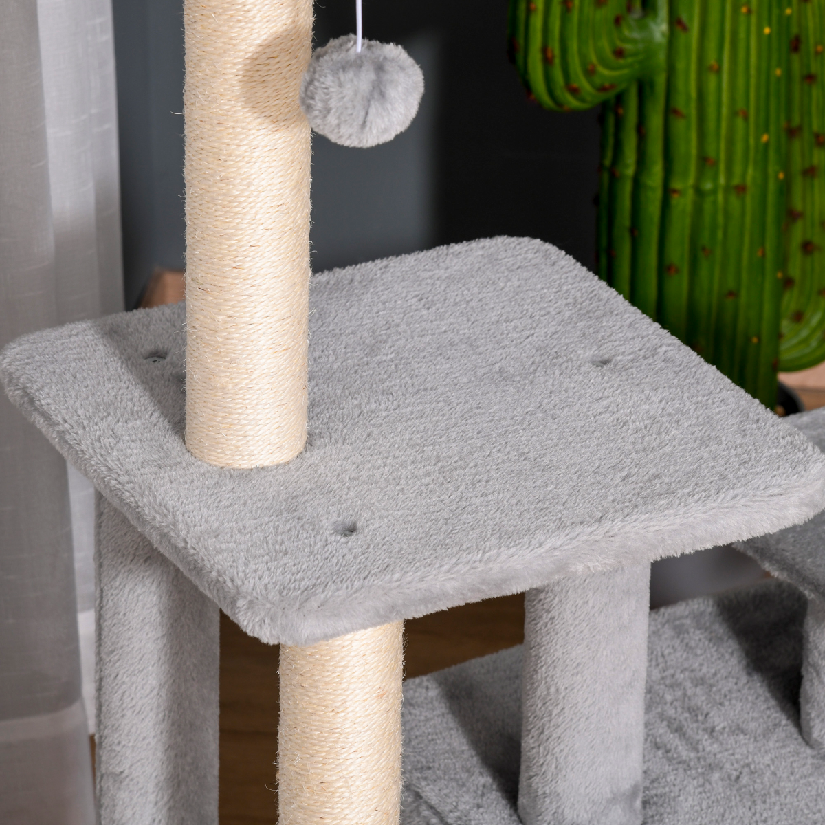 Pawhut cat tree tower with scratching posts, hanging ball, and condo, measuring 60 x 40 x 114cm, in a cozy setting.