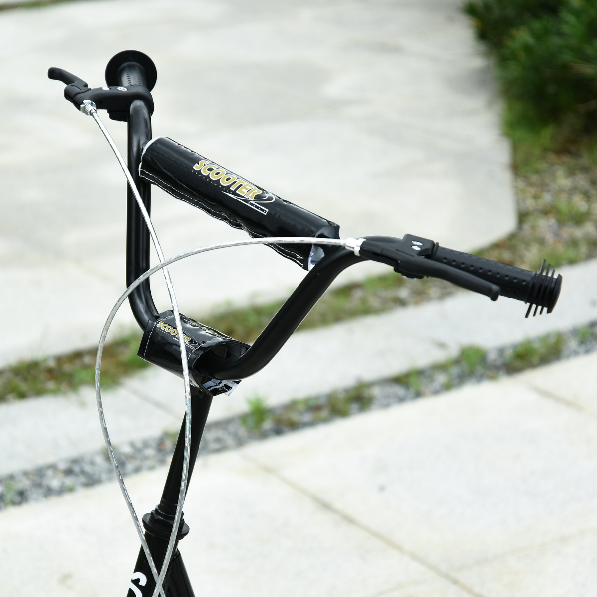 Kids kick scooter in black with adjustable handlebar and inflatable wheels, designed for ages 5 and up.