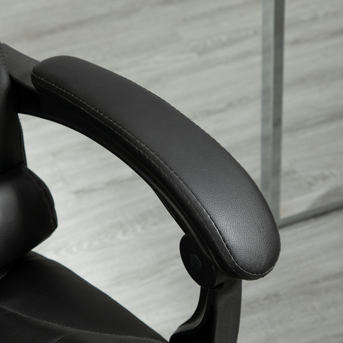 High back HOMCOM office chair in black PU leather with swivel design and footrest for ergonomic support.