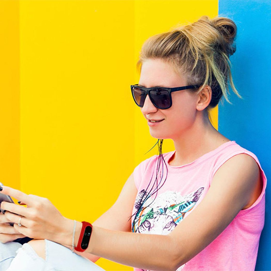 Red Aquarius AQ112 fitness tracker with heart rate monitor, featuring a sleek design and digital display for active lifestyles.