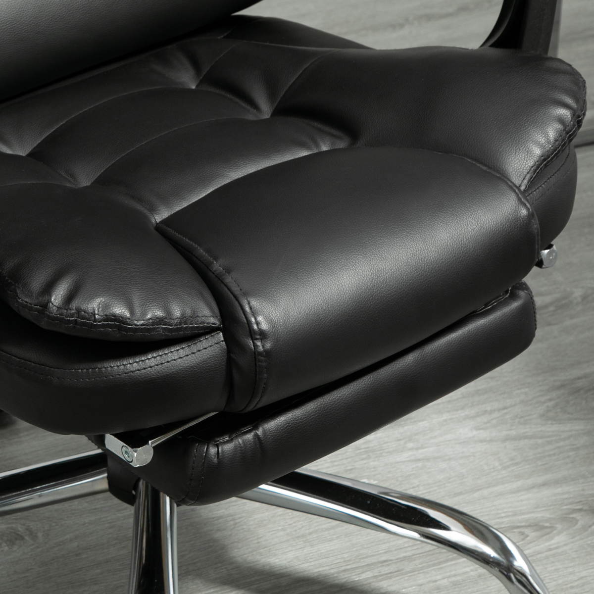 HOMCOM high back office chair in black PU leather with a footrest and swivel base, showcasing ergonomic design.