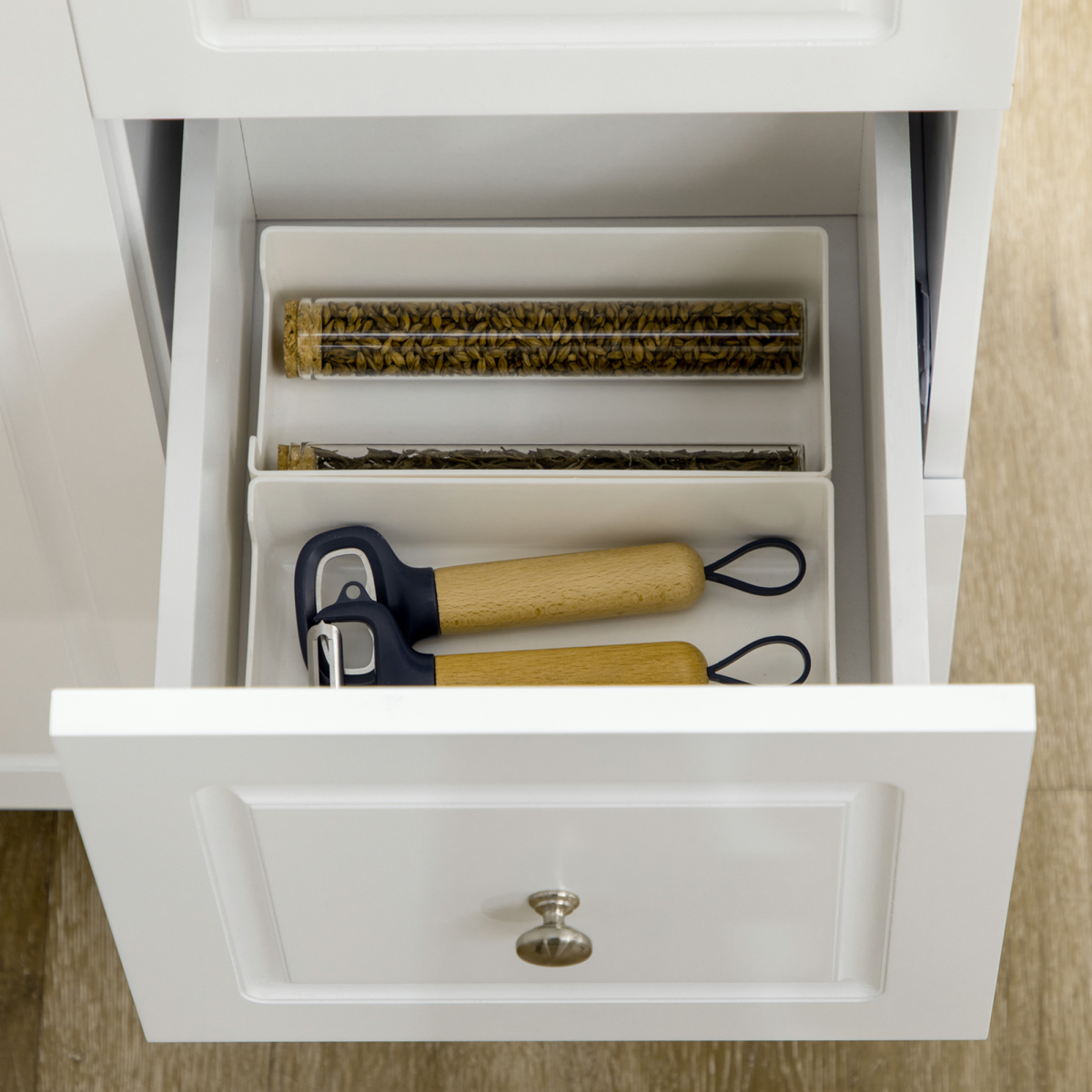 Drop-leaf kitchen island on wheels by HomeCraft, featuring drawers and a cabinet for storage and mobility.