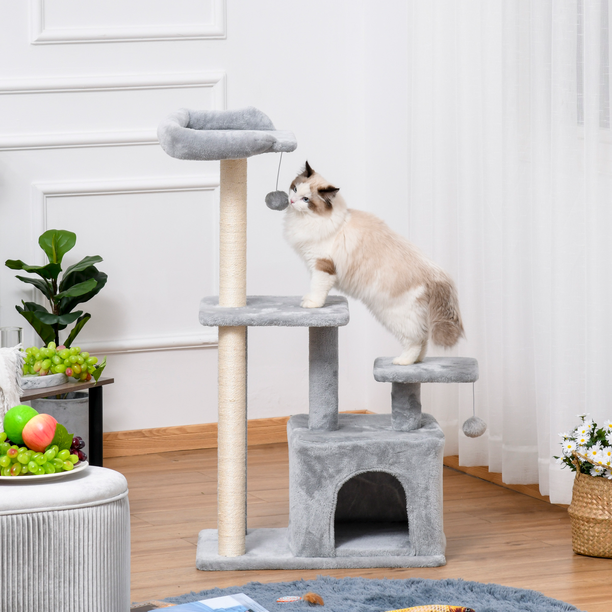 Pawhut cat tree tower with scratching posts, condo, and hanging ball, measuring 60 x 40 x 114 cm, in a cozy setting.