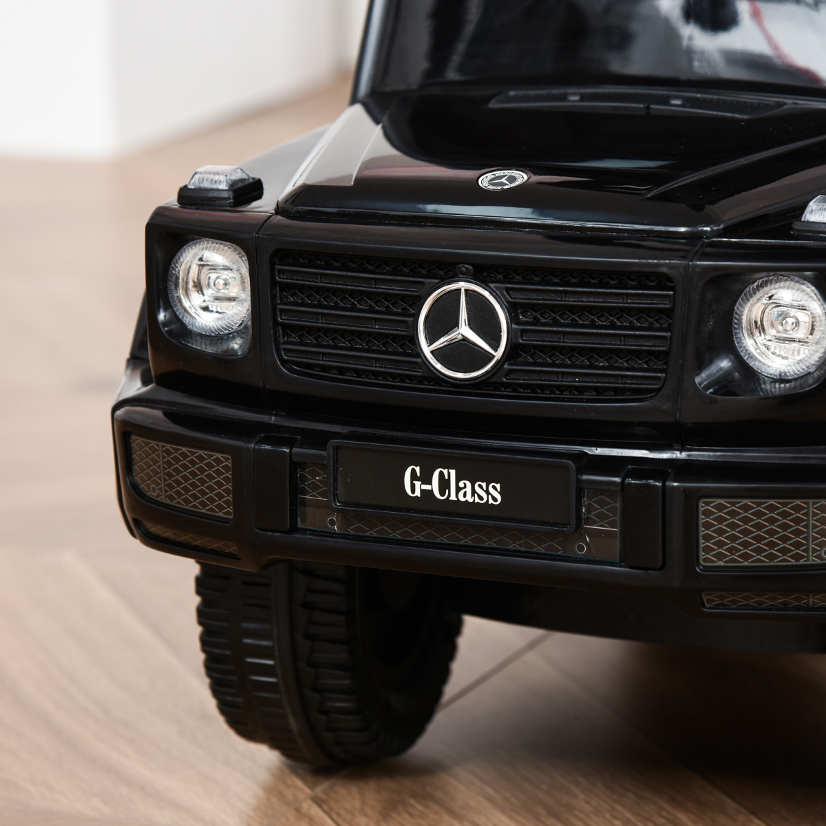 Black licensed Mercedes Benz G350 ride-on push car with sun canopy for toddlers aged 12-36 months.