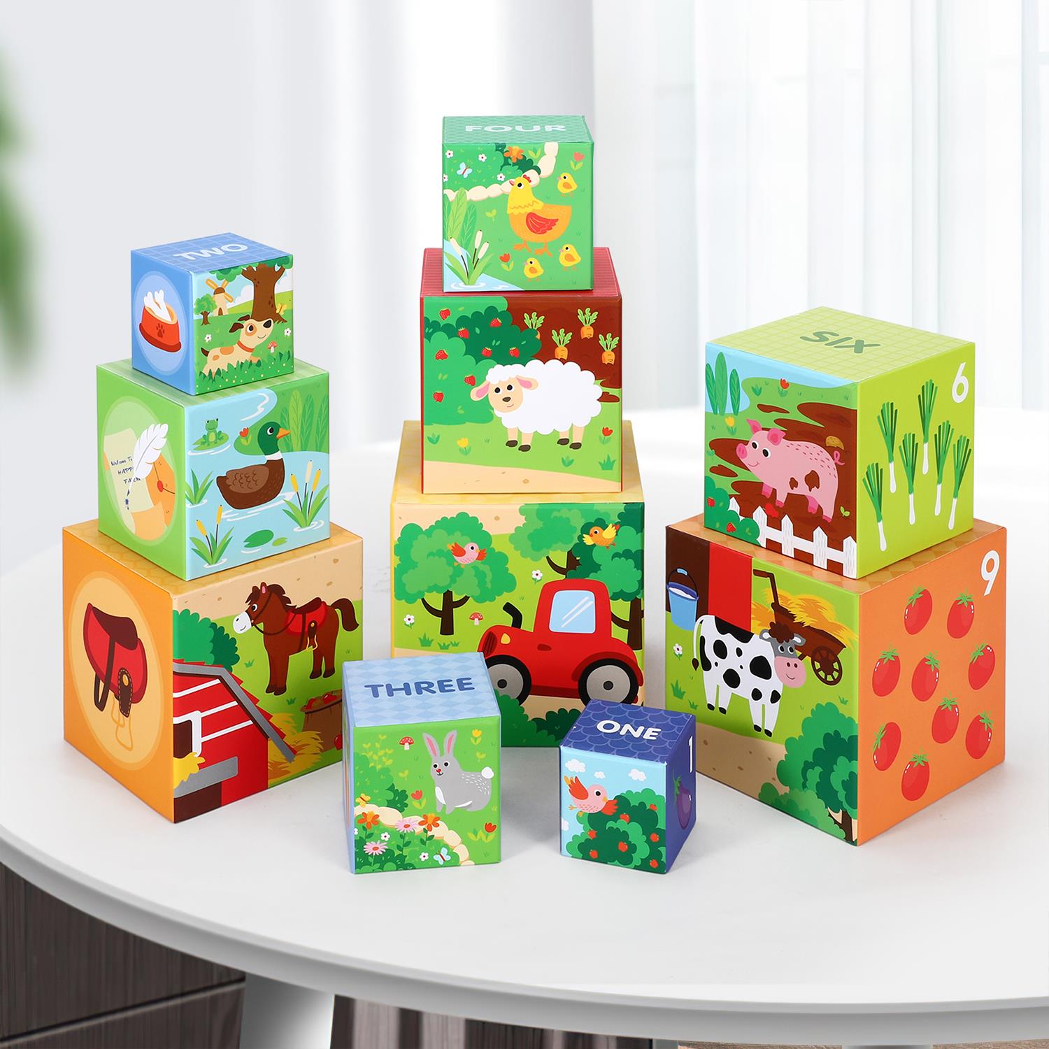 Colorful stacking cubes featuring a farm theme by SOKA Play Imagine Learn, showing animals and barn designs.