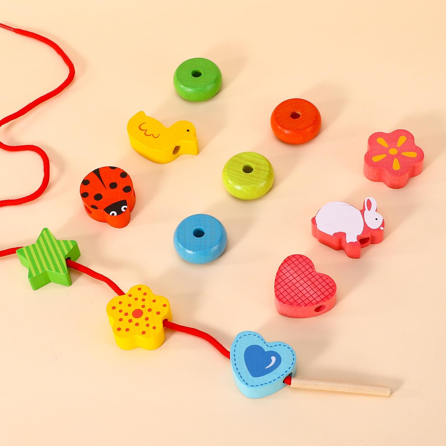 SOKA First Threading 0000457 from SOKA Play Imagine Learn, colorful threading toys arranged on a play mat.