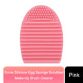 Pink and purple Silicone Egg Sponge Scrubber by GlowCare for cleaning make-up brushes.