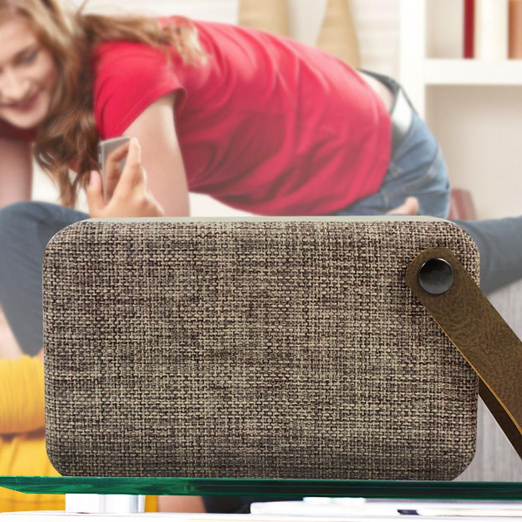 Brown Fabric Bluetooth Portable Speaker by Soundz, showcasing its sleek design and wireless connectivity features.