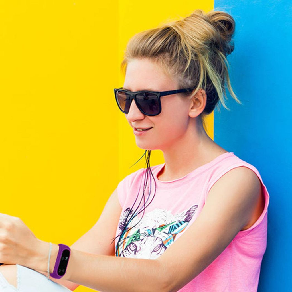 Purple Aquarius Fitness Tracker with heart rate monitor and OLED display on a white background.