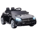 Black HOMCOM 12V Kids Electric Ride On Car with remote control and music features, parked on a driveway.